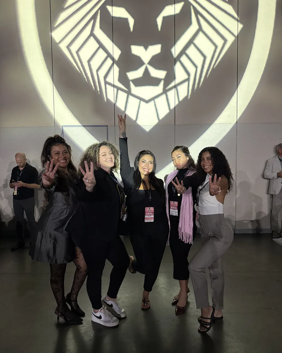 Members celebrating in front of the Alpha Society lion projection