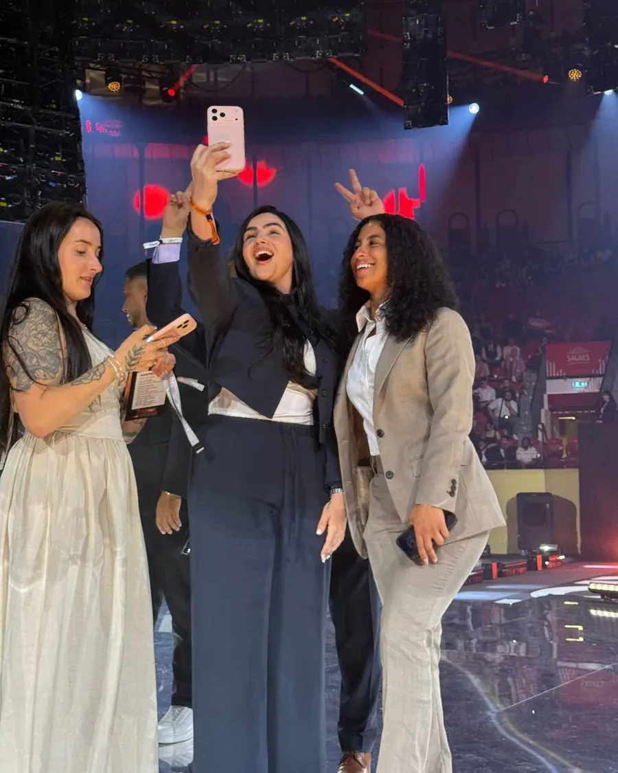 Rossy M. Peralta celebrating on stage with members at a live event